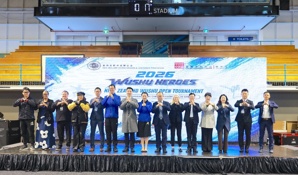 Officials salute on stage under the 2026 Wushu Heroes banner