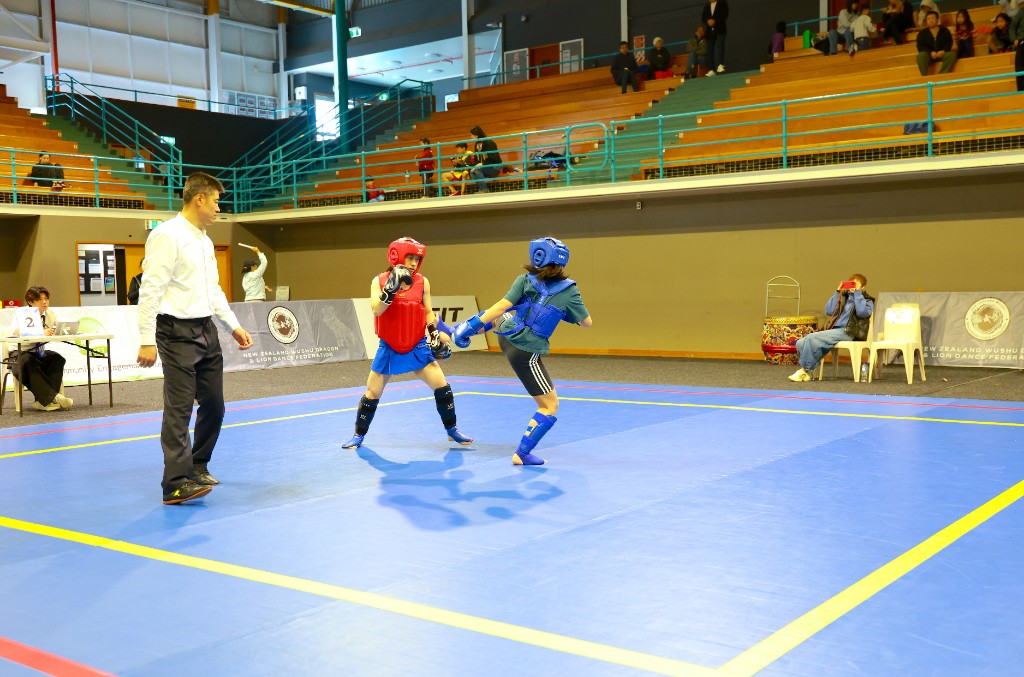 Sanda athletes sparring on the competition mat