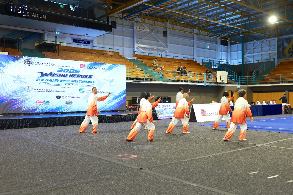 Athletes perform taolu in front of the stadium LED backdrop